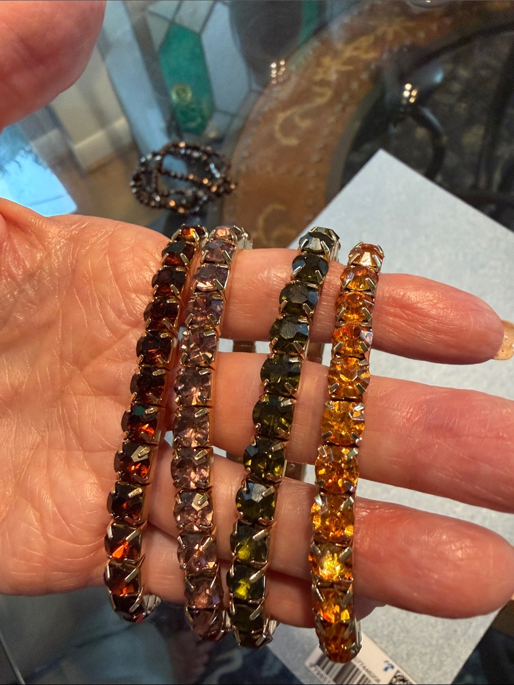 Four stretch bracelets with various stone colors.
